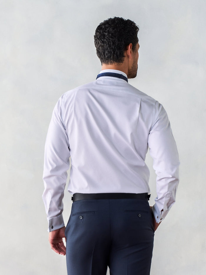 Back view of man in white wing-collar dress shirt, waist-up