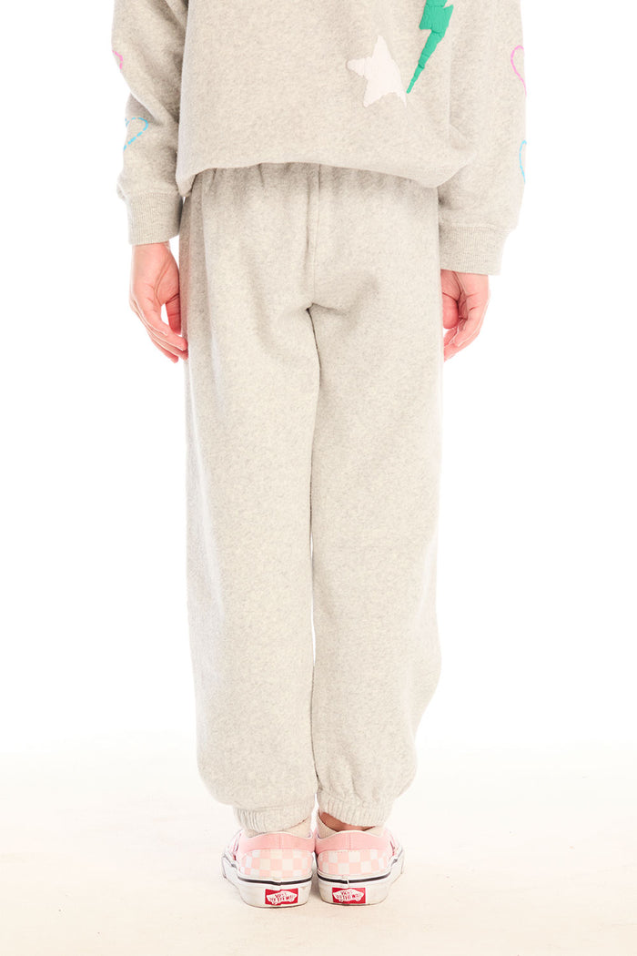 Back view of girl wearing Chaser’s light gray Winter Love Pants on a white background