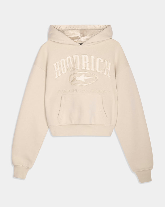 A cream-colored cropped hoodie with a tonal 'HOODRICH' graphic and logo printed on the chest, displayed against a light gray background.