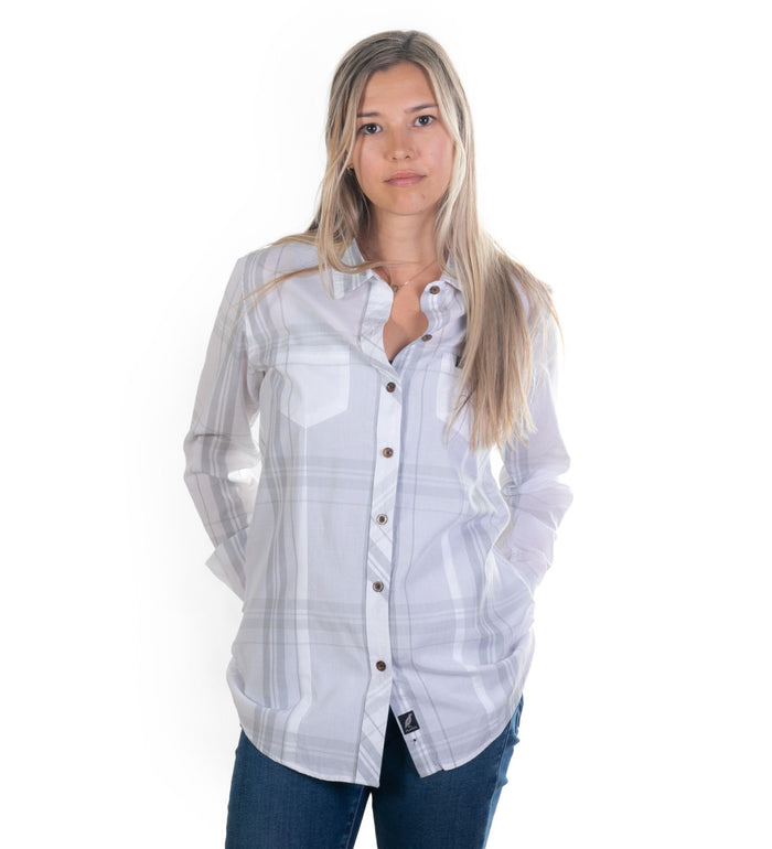 Woman wearing the Pladra Women's Breeze Shirt in Spring White with jeans, hands in pockets against a white background.