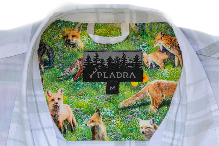 Close-up of Pladra Women's Breeze Shirt- Spring White collar with a fox and grass inner lining and Pladra label.