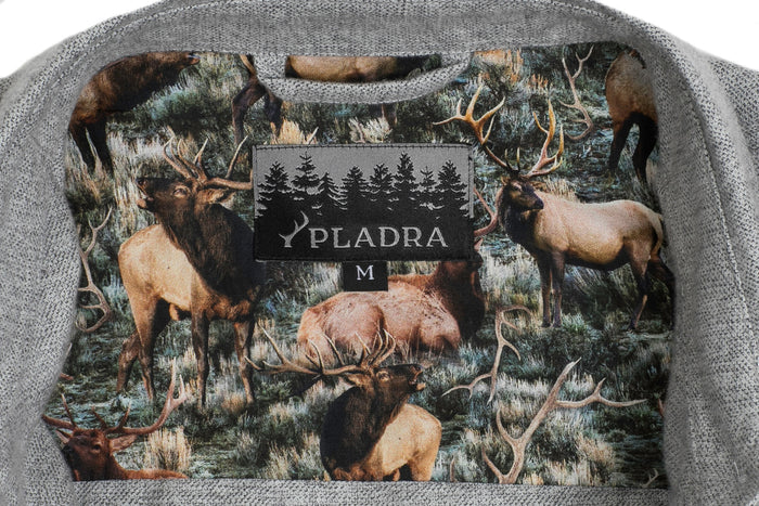 Close-up of a Pladra Women's Cascade Flannel Shirt label in Stratus Grey with forest and elk pattern on cotton lining.
