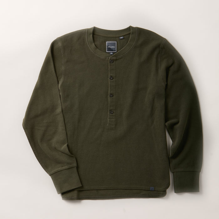 A women’s forest green Elko Henley, this mid-weight cotton shirt features long sleeves, a round neckline, and a four-button placket, shown laid flat on a light background.