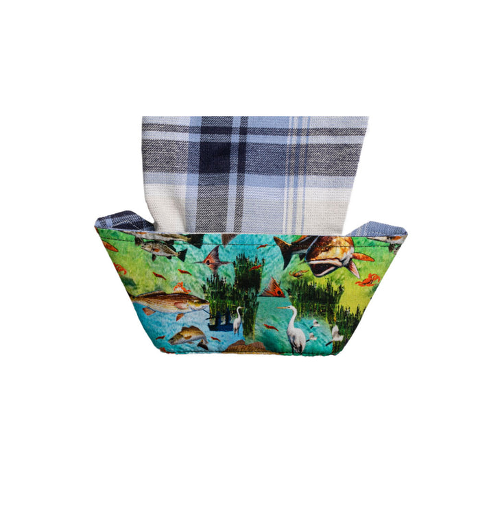 A fabric basket with a wildlife print holds a folded Pladra Women's Every Day Double Weave Shirt in Birch White.