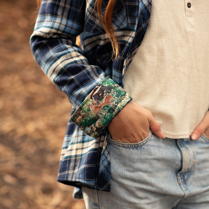 Woman outdoors in Pladra Women's Every Day Elite Flannel Shirt–Bighorn Blue, white top, light jeans, hand in pocket.