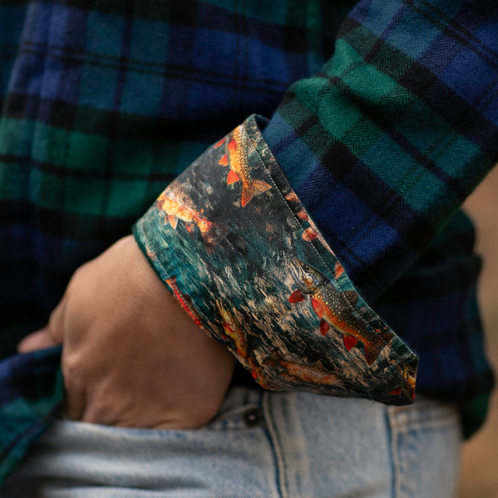 A person wears the Pladra Women's Every Day Flannel Shirt in Bolinas Blue with light-wash jeans.