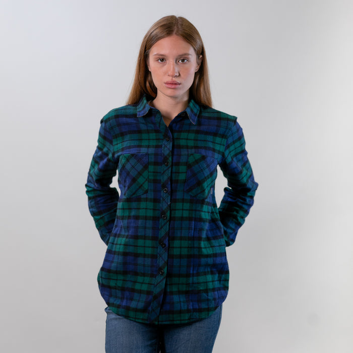 A woman wears the Pladra Women's Every Day Flannel Shirt in Bolinas Blue against a plain light background.