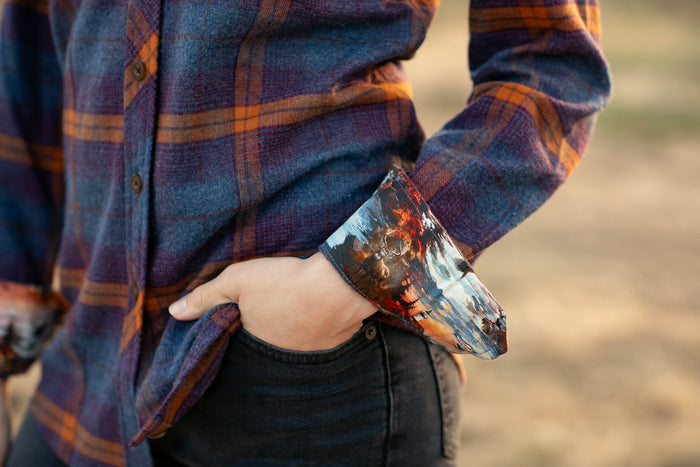 Woman wearing Pladra Women's Every Day Flannel Shirt–Portsmouth Blue Heather, patterned cuff, with black jeans outdoors.