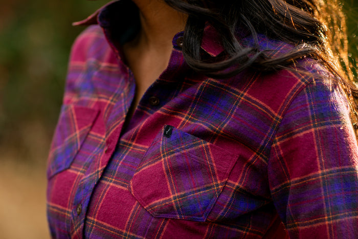 Close-up of a woman outdoors in sunlight wearing the Pladra Women's Every Day Flannel Shirt–RK Plum Red.