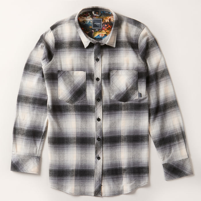 The Women's Every Day Flannel Shirt in Sterling Grey Heather is made from soft cotton flannel, features a black, white, and gray plaid design with two chest pockets and black buttons, shown laid flat on a light background.