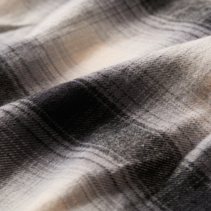 Close-up of the Women's Every Day Flannel Shirt in Sterling Grey Heather, showcasing its soft black and white plaid cotton flannel fabric with a subtle checkered pattern, gentle folds, and cozy texture.