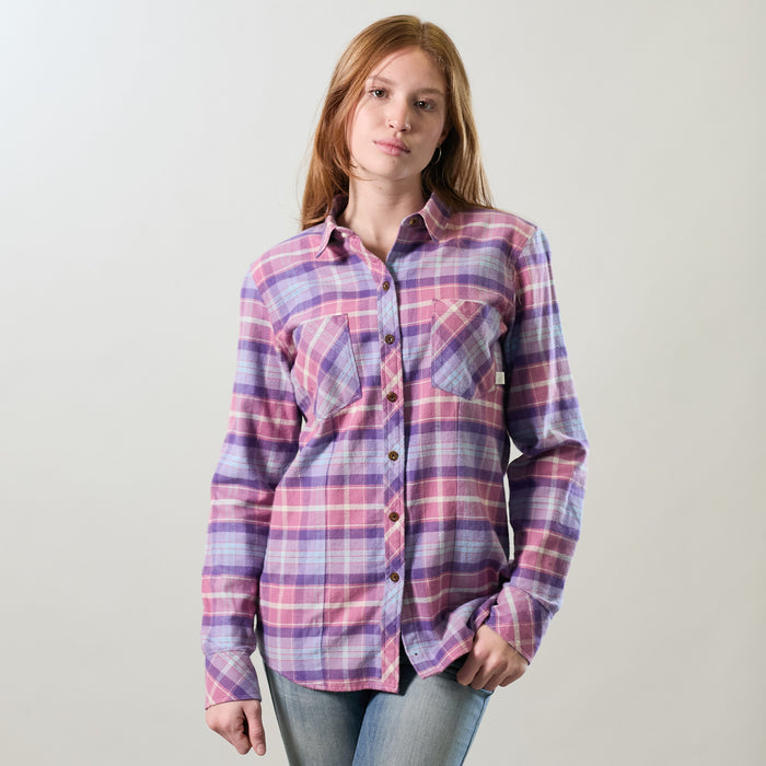 A woman wears the Pladra Women's Every Day Flannel Shirt in Wildflower Pink and jeans against a plain light background.