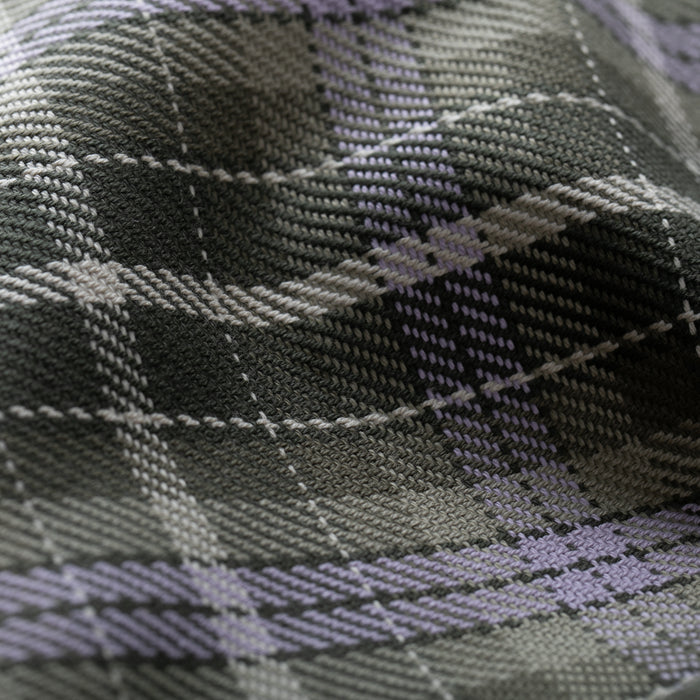 Close-up of heavyweight Portuguese flannel from the Women's Fireside Flannel - Grove Green, featuring a textured woven look. Soft folds in green plaid create dimension and depth across the patterned surface.