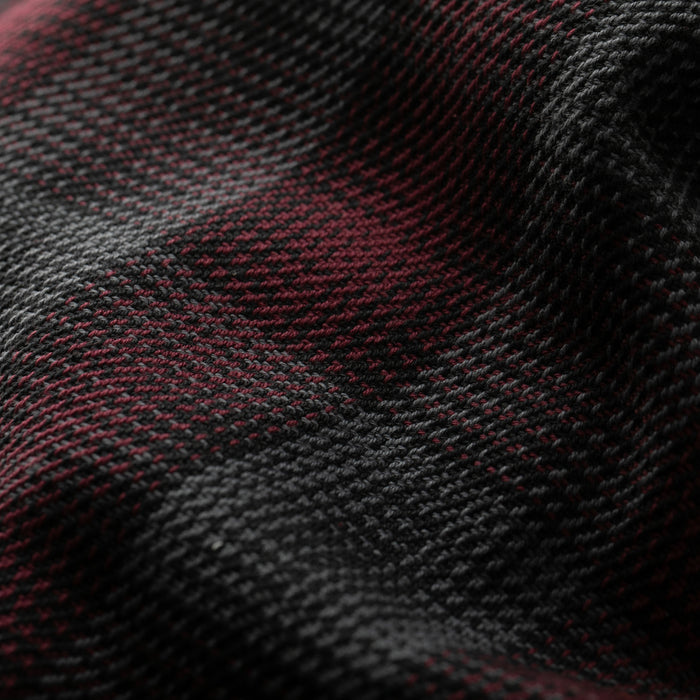 Close-up of the Women's Fireside Flannel in Hickory Red, highlighting its heavyweight textured fabric and black-and-dark-red plaid pattern with detailed weave and folds.