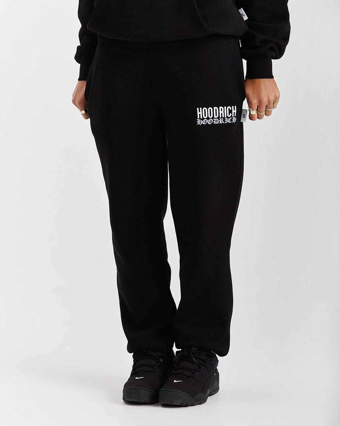 Person wearing black sweatpants with 'Hoodrich' logo on a white background