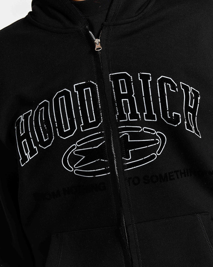Close-up of a black zip-up hoodie with a distressed white graphic reading 'HOOD RICH' and a stylized emblem on the front.