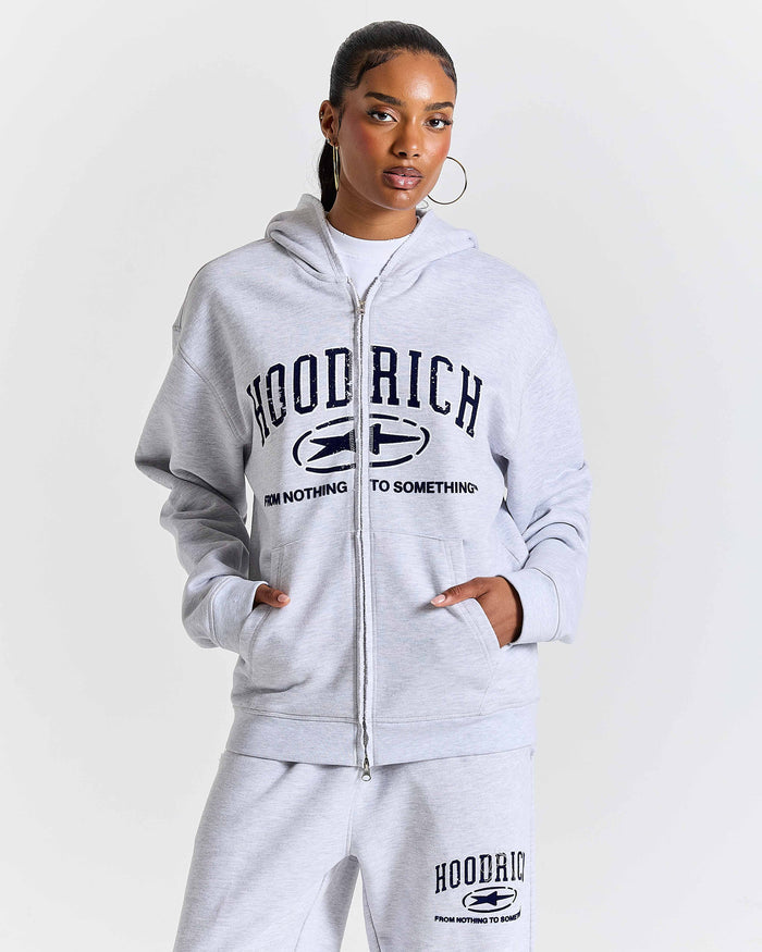 Person wearing a gray 'Hood Rich' tracksuit on a white background