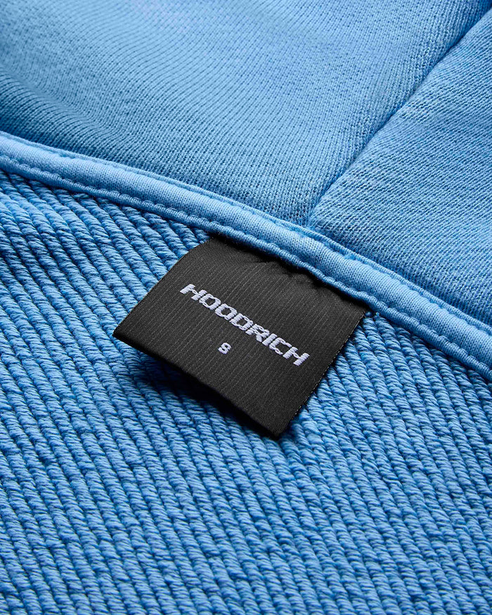 Close-up of the internal Hoodrich neck label showing size small on the blue cropped hoodie.