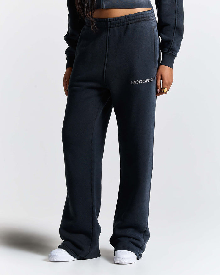 Person wearing black sweatpants with 'Hoodrich' branding on a white background