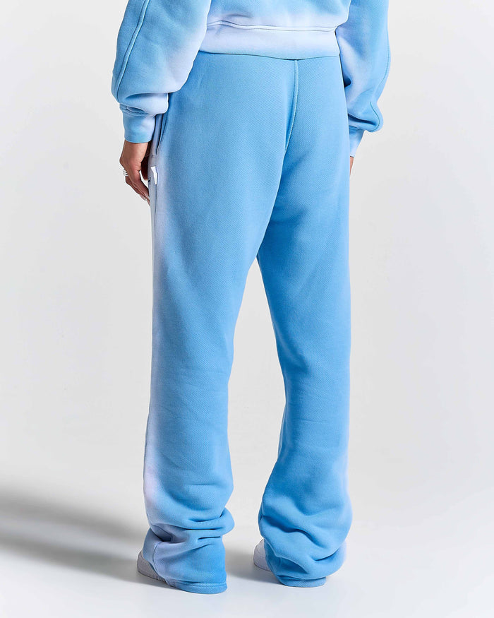 Light blue sweatpants worn by a model on a white background