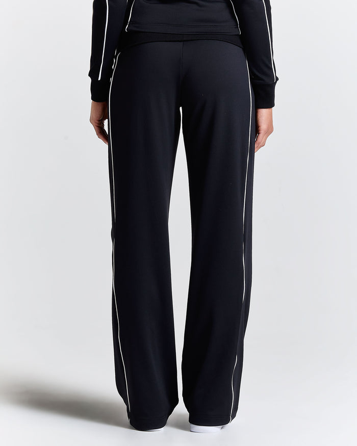 Displays a model wearing the Black 'Hoodrich' branded women's Glide Football Full Tracksuit