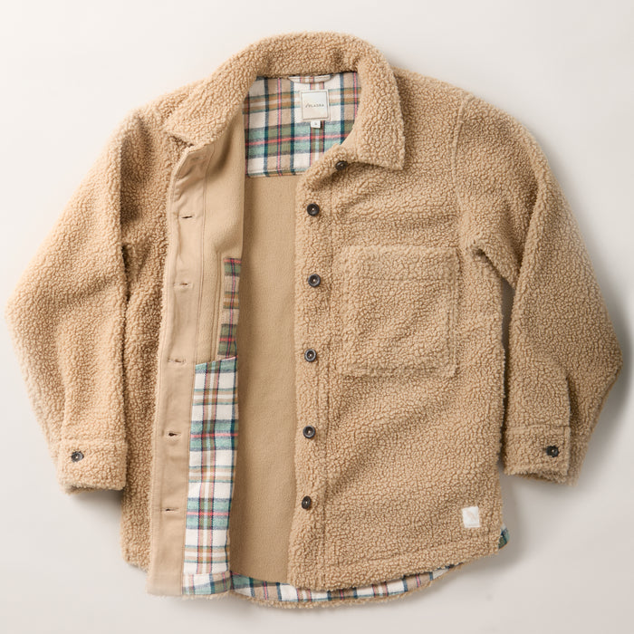 Pladra Women's Headlands Sherpa Shacket in Almond Tan with buttons and plaid flannel lining, shown flat on white.