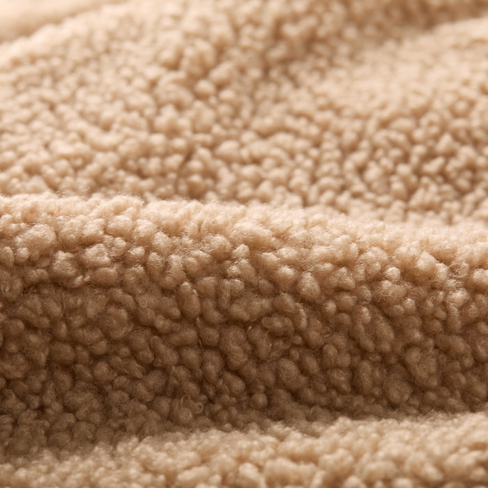 Close-up of soft, textured fleece from Pladra Women's Headlands Sherpa Shacket in Almond Tan with a fluffy surface.