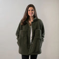 Woman wearing Pladra's Women's Headlands Sherpa Shacket in Forest Green, standing and smiling at the camera.