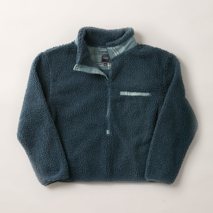 The Women's Jenner Sherpa Fleece in Atlantic Blue is a long-sleeve pullover made from recycled polyester with a half-zip front, stand collar, small chest pocket, and light blue trim for added style.