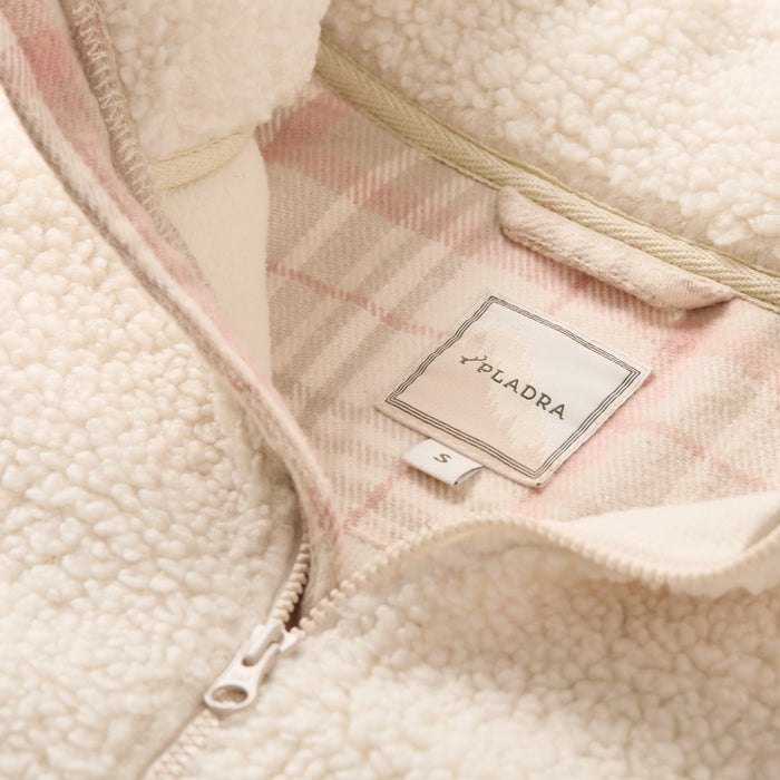 Close-up of Pladra Women's Jenner Sherpa Fleece in Oatmeal White, size S tag, with pink plaid flannel lining.