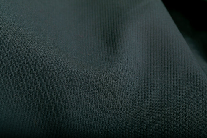 Close-up of Fir Green Pincord cotton from Pladra's Women's Leon Workhorse Shirt, showing its subtle ribbed texture.