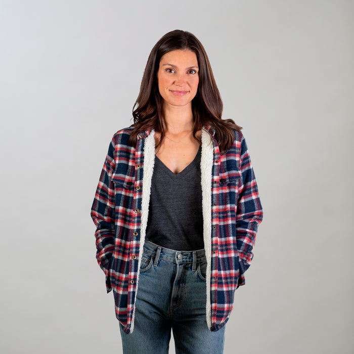 Women's Northwood Sherpa Insulated Flannel Jacket in Eagle Blue, worn over a dark grey V-neck with blue jeans.