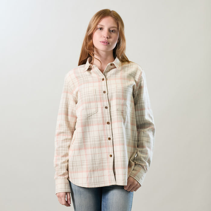 A woman with long, light brown hair wears the Women's Relaxed Every Day Elite Flannel Shirt in Lighthouse White and blue jeans, standing against a plain, light background.