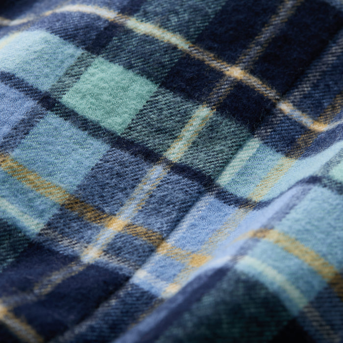 Close-up of the Women's Every Day Flannel Shirt- Bay Blue, highlighting its soft Portuguese flannel fabric in a blue, navy, green, and yellow plaid pattern with visible woven texture and intersecting stripes.