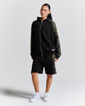 Displays a model wearing the Black camo 'Hoodrich' branded women's Shade Matching Shorts Set