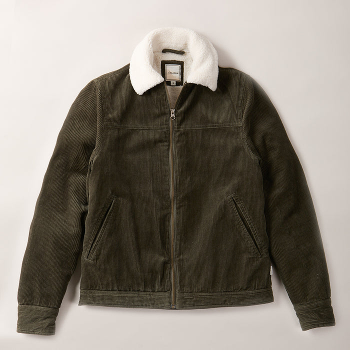 A Women's Stinson Jacket in pine green cotton corduroy with a white faux fur collar, front zipper, and two slanted pockets is shown laid flat on a light background.