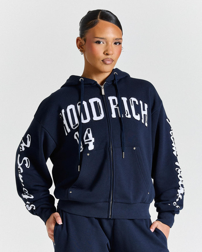 Person wearing a navy blue hoodie with white text on a light gray background