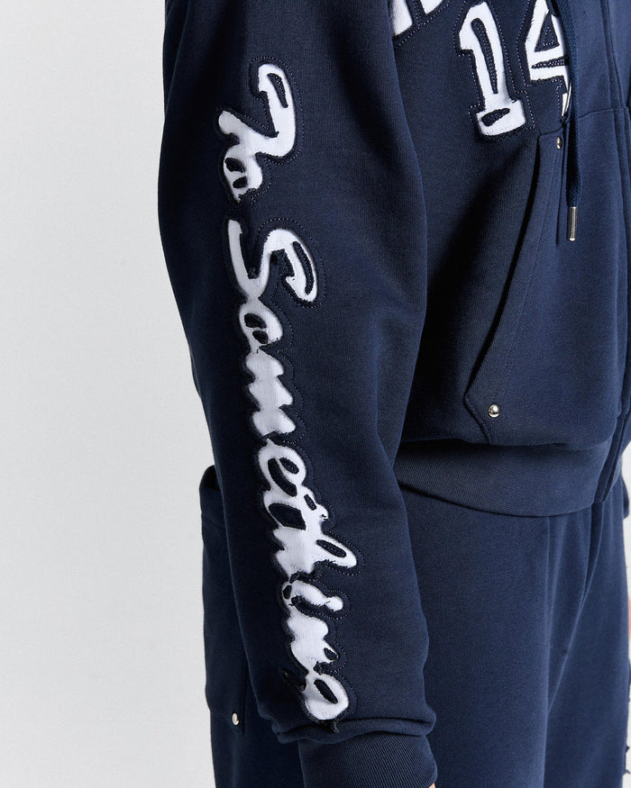 Navy tracksuit with white text on a light gray background