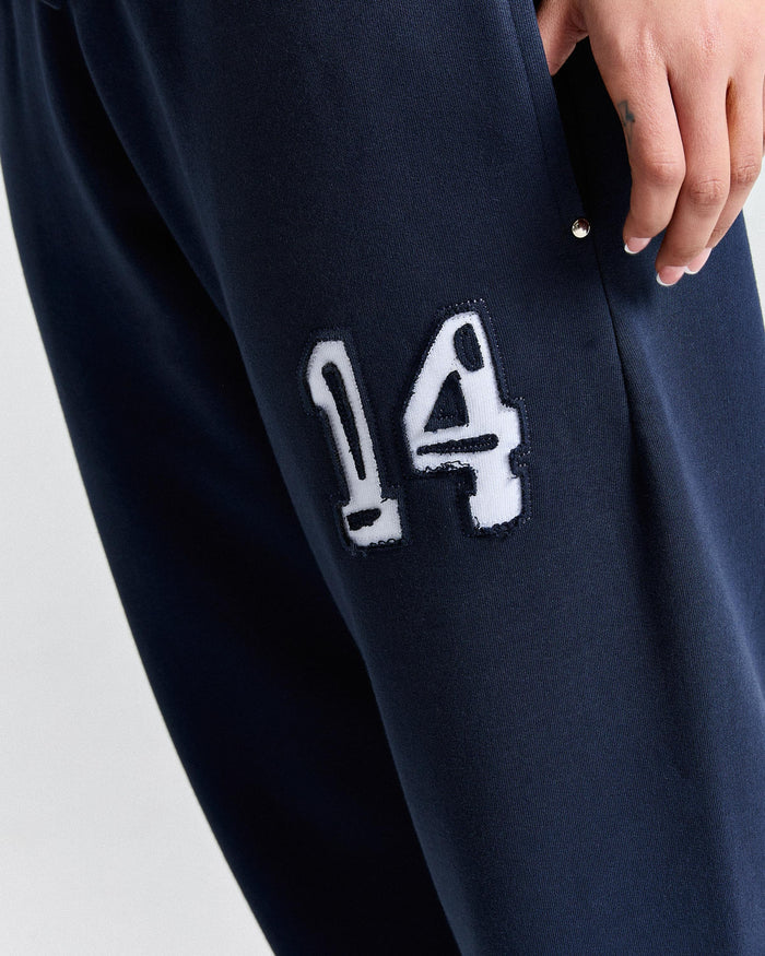 Navy blue sweatpants with a white number 14 patch on a light gray background