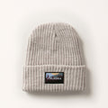Woodsman Heavyweight Cuff Beanie in Cloud White, a light grey knit with a folded brim and a mountain landscape patch. Made in the USA.