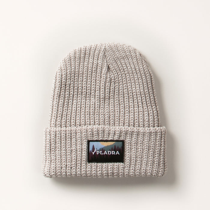 Woodsman Heavyweight Cuff Beanie in Cloud White, a light grey knit with a folded brim and a mountain landscape patch. Made in the USA.