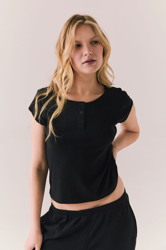 Black henley tee with button neckline and slim fit.