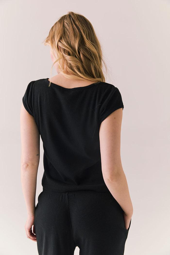 Back of black henley tee with clean shape and stretch fabric.