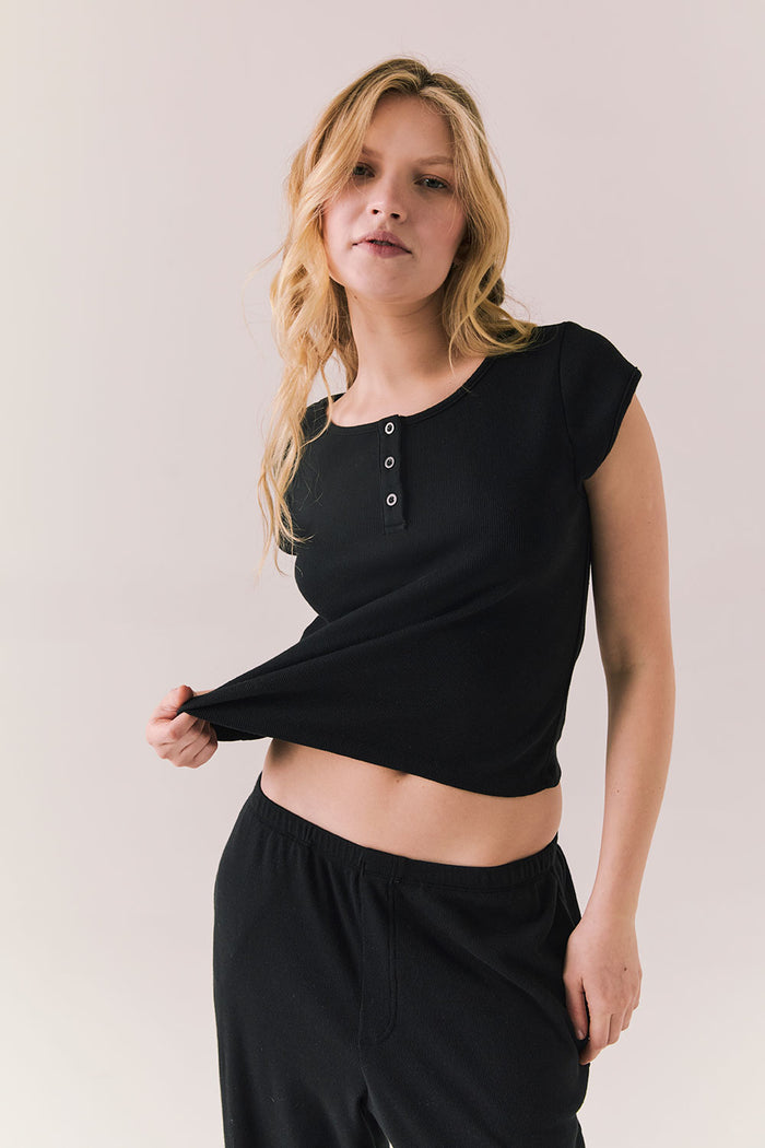 Black henley tee with button neckline and slim fit.
