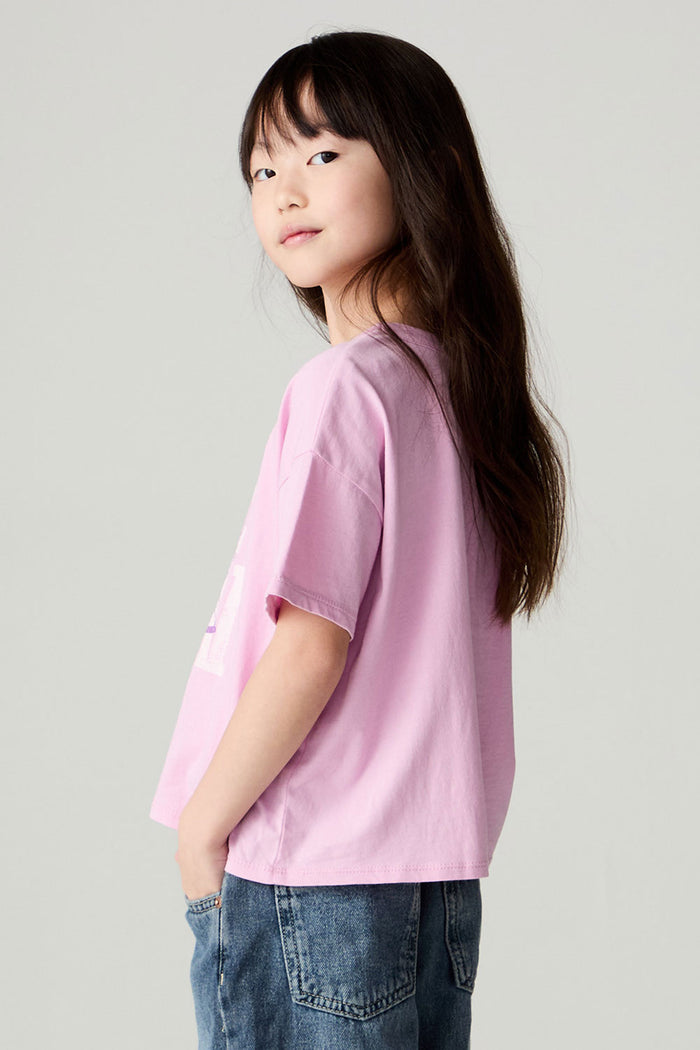 Back view of a girl wearing the Chaser Yee Haw Girls Tee and jeans on a neutral background