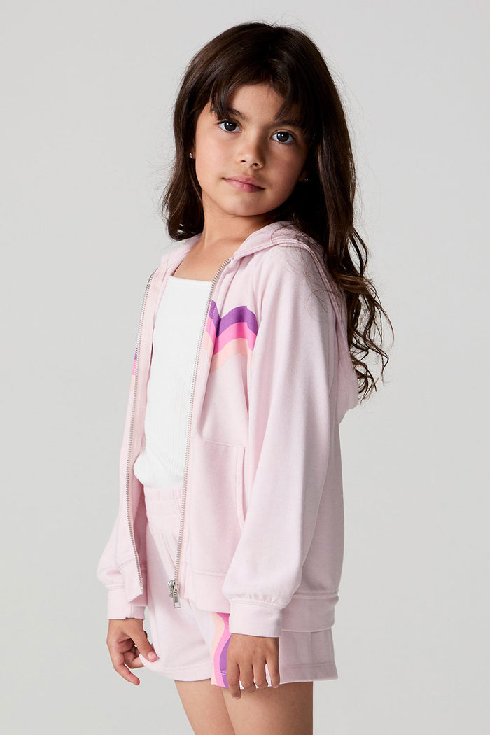 Side angle view of a girl wearing the Chaser Zip Up Begonia Hoodie on a neutral background